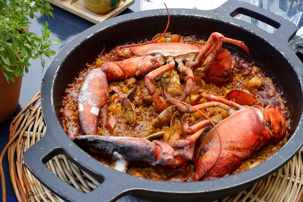 Traditional Mediterranean seafood dish served at the panoramic restaurant of Parador de Aiguablava in Costa Brava.