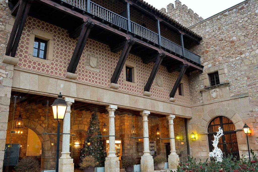 The stone courtyard of the 12th-century medieval castle hotel at Parador de Siguenza in Guadalajara, Spain.