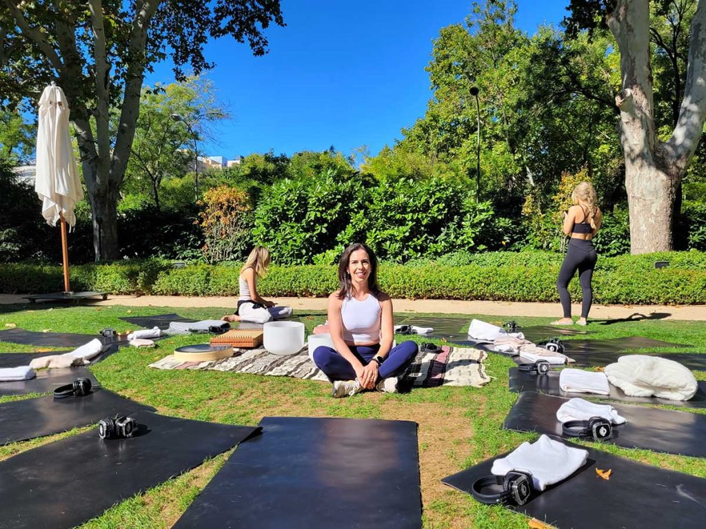 Guests enjoying an outdoor yoga session in the exclusive garden of Rosewood Villa Magna luxury hotel in Madrid